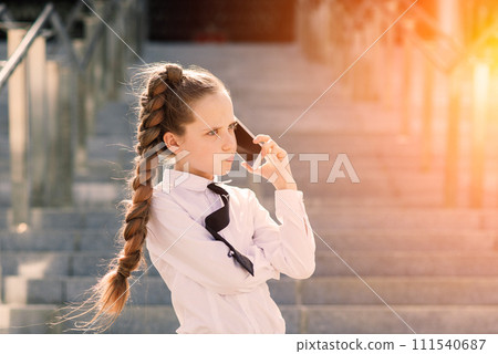 Little school girl having phone talk with friend. modern life communication. Living in digital age. 111540687
