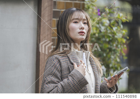 A woman in her 20s with a smartphone A woman in her 20s with a smartphone 111540898