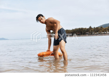 Guardian of the Seas: A Vigilant Lifeguard Ensuring Safety and Joy on the Asian Beach 111541456