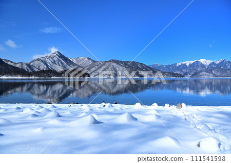 Nikko City, Tochigi Prefecture, Mt. Shayama and Mt. Shirane seen from Lake Chuzenji covered with snow in winter 111541598
