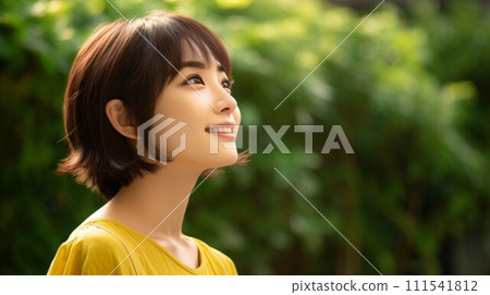 A woman smiling in the fresh greenery 111541812