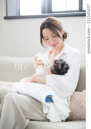 Close-up of a woman feeding milk to a baby, so cute and precious 111541857