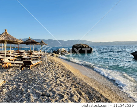 Rocky beach and crystal turquoise water of Ionian Sea in Albania. Rocky beach and crystal turquoise water of Ionian Sea in Albania. 111542529
