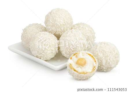 round candy raffaello with coconut flakes and nut in ceramic bowl isolated on white background 111543053