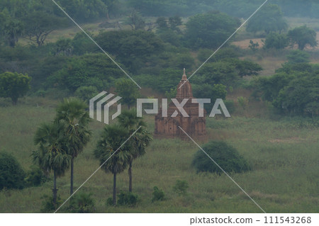 Aerial top view of burmese temples of Bagan City from a balloon, unesco world heritage with forest trees, Myanmar or Burma. Tourist destination. 111543268