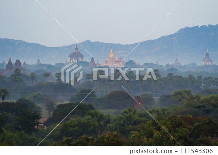 Aerial top view of burmese temples of Bagan City from a balloon, unesco world heritage with forest trees, Myanmar or Burma. Tourist destination. 111543306