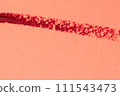 Red lipstick stroke on a red background close-up macro photography. 111543473