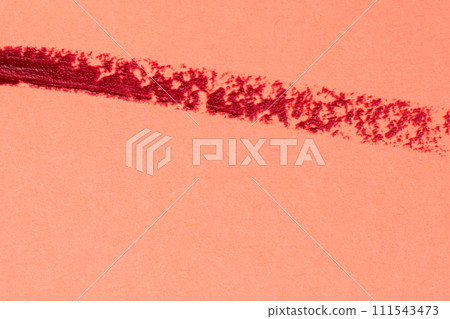 Red lipstick stroke on a red background close-up macro photography. 111543473