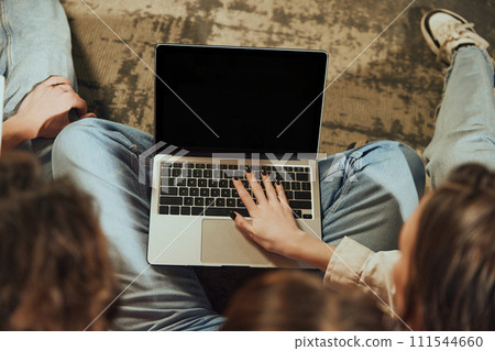 Top view image of laptop. Young people using computer for online reservation, buying tickets and booking hotels via Internet services 111544660
