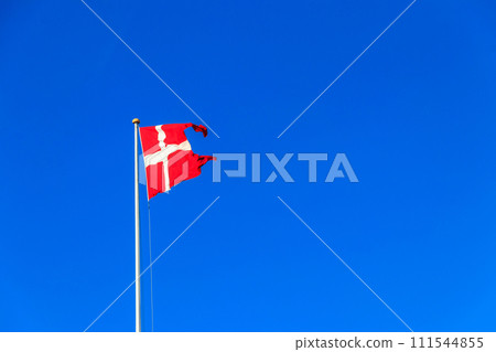 Flag of Denmark against blue sky Flag of Denmark against blue sky 111544855