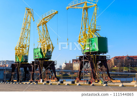 Old cranes on city boulevard in Szczecin, Poland Old cranes on city boulevard in Szczecin, Poland 111544865