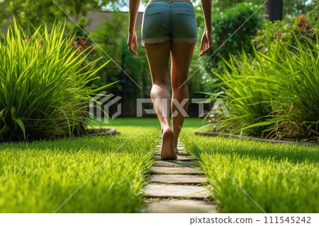 Woman Walking on Garden Path 111545242