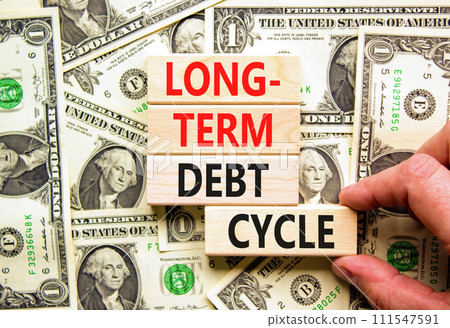 Long-term debt cycle symbol. Concept words Long-term debt cycle on beautiful wooden block. Beautiful dollar bills background. Dollar bills. Business Long-term debt cycle concept. Copy space Long-term debt cycle symbol. Concept words Long-term debt cycle on beautiful wooden block. Beautiful dollar bills background. Dollar bills. Business Long-term debt cycle concept. Copy space 111547591