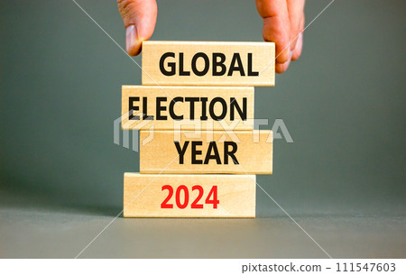Global election year 2024 symbol. Concept words Global election year 2024 on beautiful block. Beautiful grey table grey background. Voter hand. Business Global election year 2024 concept. Copy space. Global election year 2024 symbol. Concept words Global election year 2024 on beautiful block. Beautiful grey table grey background. Voter hand. Business Global election year 2024 concept. Copy space. 111547603
