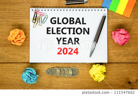 Global election year 2024 symbol. Concept words Global election year 2024 on beautiful white note. Beautiful wooden table background. Paper. Business Global election year 2024 concept. Copy space 111547682