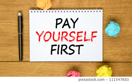 Pay yourself first symbol. Concept words Pay yourself first on beautiful white note. Beautiful wooden background. Black pen. Colored paper. Business and pay yourself first concept. Copy space. 111547683