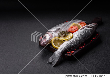 Fresh raw ocean sea bass fish with salt, spices and herbs 111548448