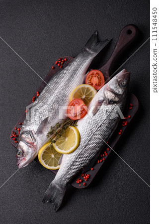 Fresh raw ocean sea bass fish with salt, spices and herbs Fresh raw ocean sea bass fish with salt, spices and herbs 111548450