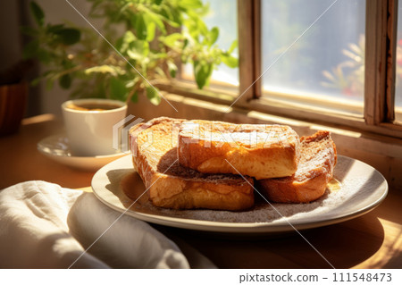 Traditional Spanish dessert Torrijas. Heap of a deep fried sweet bread on a plate in the sunlight 111548473