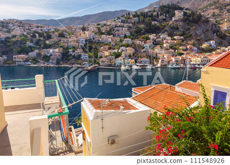 Multi-colored facades of houses in the Greek village Symi on a sunny day 111548926