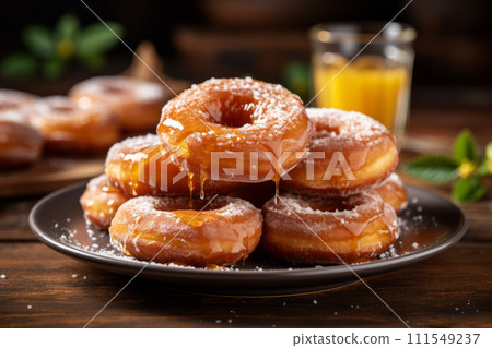 A heap of homemade freshly baked glazed donuts with sugar powder on the plate 111549237