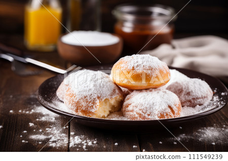 Freshly baked cheese donuts in ball shape with powdered sugar on a plate 111549239