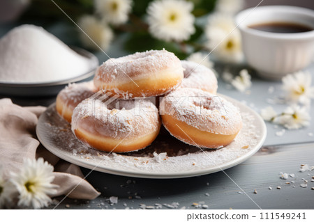 Freshly baked homemade donuts with powdered sugar on white plate, on the wooden table 111549241