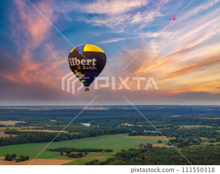 Aerial summer sunny sunset view of hot air balloon over Galve lake, Lithuania Aerial summer sunny sunset view of hot air balloon over Galve lake, Lithuania 111550318
