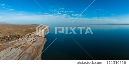 Aerial view over Salton sea in California. Huge lake in the middle of a desert at sunset. Aerial view over Salton sea in California. Huge lake in the middle of a desert at sunset. 111550336