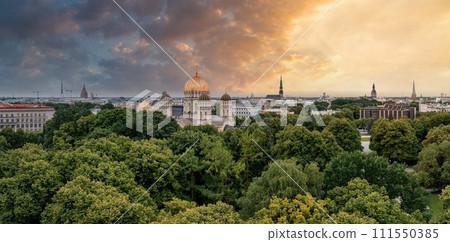 The Nativity of Christ Cathedral in Riga, Latvia. Byzantine-styled Orthodox cathedral, the largest in the Baltic region, with golden colored dome, polished gilded cupolas gleaming through the trees 111550385
