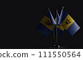 Small national flags of the Barbados on a black background 111550564