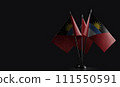 Small national flags of the Antigua and Barbuda on a black background 111550591