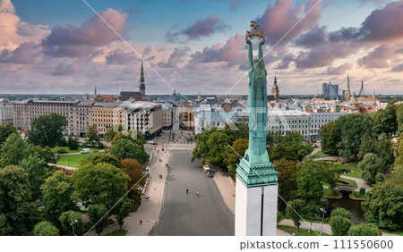 Beautiful sunrise view over Riga by the statue of liberty - Milda in Latvia. The monument of freedom. 111550600