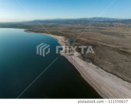 Aerial view over Salton sea in California. Huge lake in the middle of a desert at sunset. Aerial view over Salton sea in California. Huge lake in the middle of a desert at sunset. 111550627