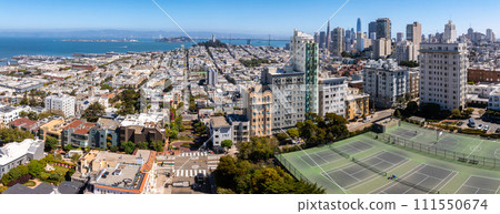Panoramic view of aerial Lombard Street, an east west street in San Francisco, California. Famous for steep, one block section with eight hairpin turns. Tennis courts in San Francisco. 111550674