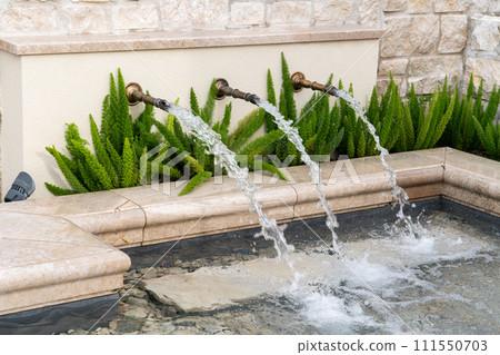 Decorative fountain on a city street. Decorative fountain on a city street. 111550703