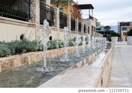 Decorative fountain on a city street. Decorative fountain on a city street. 111550711