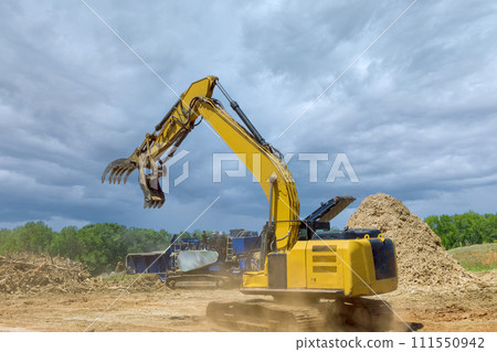 Forestry mulcher in loading roots trees to of industrial shredder machine chopped wooding 111550942