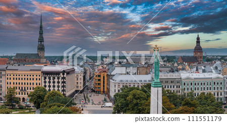 Beautiful sunrise view over Riga by the statue of liberty - Milda in Latvia. The monument of freedom. Beautiful sunrise view over Riga by the statue of liberty - Milda in Latvia. The monument of freedom. 111551179