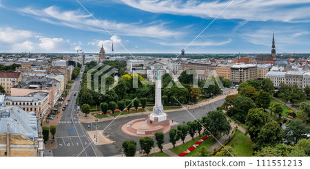 Beautiful sunrise view over Riga by the statue of liberty - Milda in Latvia. The monument of freedom. Beautiful sunrise view over Riga by the statue of liberty - Milda in Latvia. The monument of freedom. 111551213