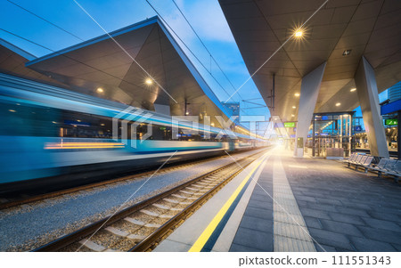 High speed train in motion on the railway station at night High speed train in motion on the railway station at night 111551343