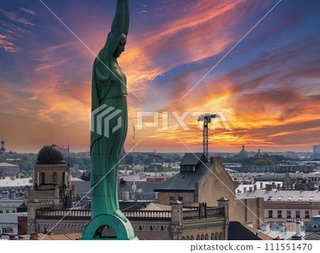 Beautiful sunrise view over Riga by the statue of liberty - Milda in Latvia. The monument of freedom. 111551470