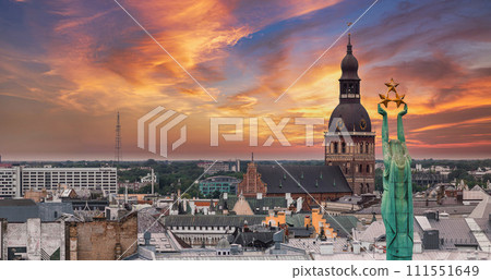 Beautiful sunrise view over Riga by the statue of liberty - Milda in Latvia. The monument of freedom. 111551649