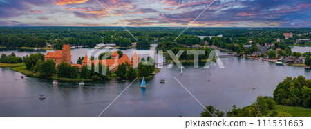 Aerial view of Trakai, over medieval gothic Island castle in Galve lake. Flat lay of the most beautiful Lithuanian landmark. Trakai Island Castle, most popular tourist destination in Lithuania Aerial view of Trakai, over medieval gothic Island castle in Galve lake. Flat lay of the most beautiful Lithuanian landmark. Trakai Island Castle, most popular tourist destination in Lithuania 111551663