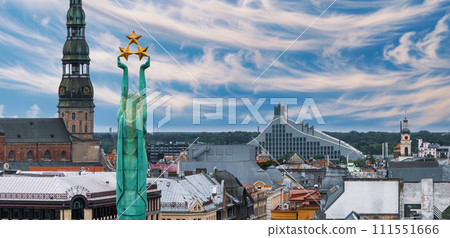 Beautiful sunrise view over Riga by the statue of liberty - Milda in Latvia. The monument of freedom. Beautiful sunrise view over Riga by the statue of liberty - Milda in Latvia. The monument of freedom. 111551666
