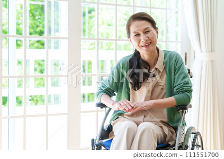 Portrait of a middle-aged woman in a wheelchair Portrait of a middle-aged woman in a wheelchair 111551700