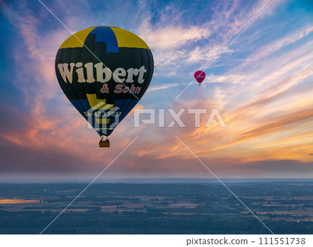 Aerial summer sunny sunset view of hot air balloon over Galve lake, Lithuania Aerial summer sunny sunset view of hot air balloon over Galve lake, Lithuania 111551738