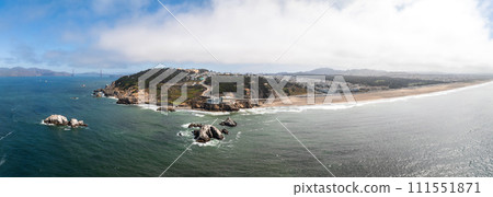 Where the sea meets the land in San Francisco. Ocean Beach is a world renowned surfing beach in the Sunset district of San Francisco. Cliff house building on the cliffs. 111551871