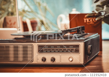 Closeup of vintage record player turntable with record inside old room 111552410