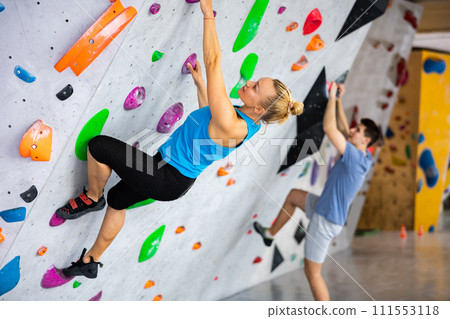 Woman exercising in climbing gym 111553118